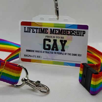 Gay membership card with a gay pride lanyard behind on a plain white background